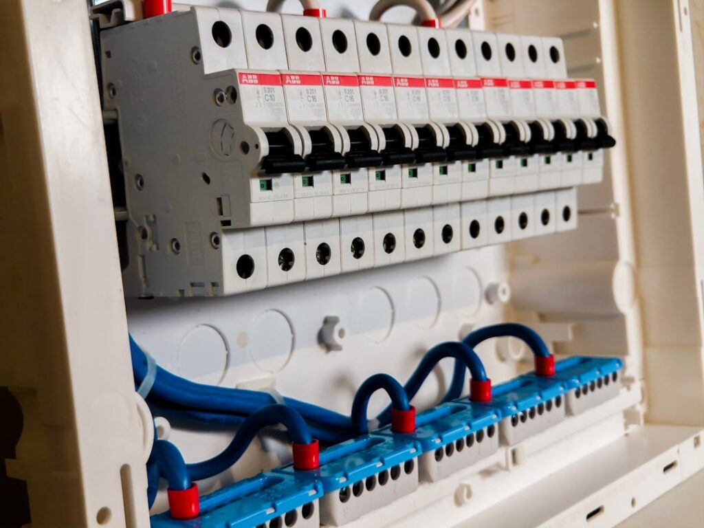 ABB miniature circuit breakers on DIN rail in a distribution panel — rated current and thermal derating must account for Gulf ambient temperatures up to 55 degrees Celsius