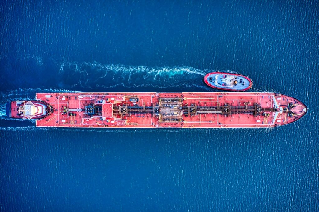 Aerial view of red oil tanker at sea showing fuel cargo vessel operations relevant to HFO and marine fuel types