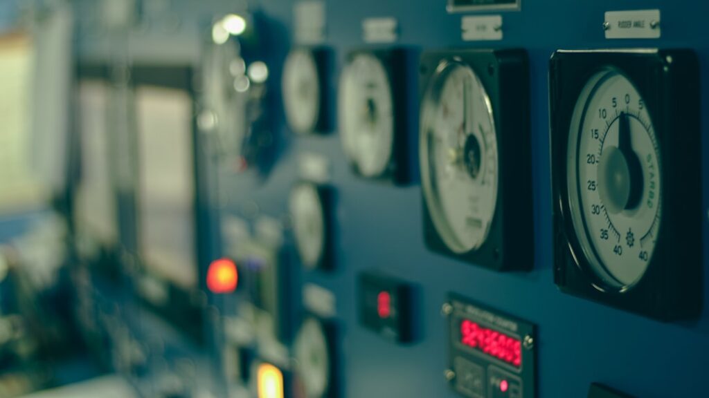 Marine vessel engine control panel with pressure gauges and monitoring instruments used to track differential pressure and filter condition