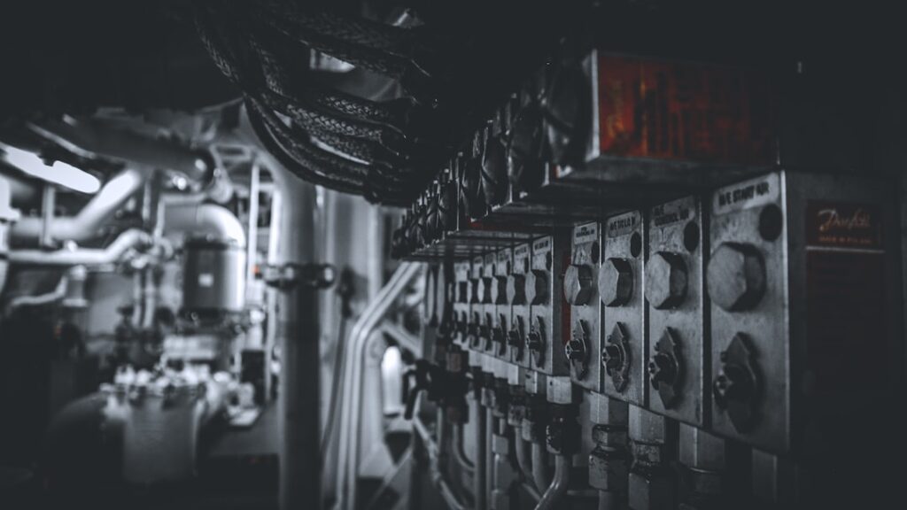 Pressure transmitters and monitoring gauges inside a commercial ship engine room, illustrating hydraulic system pressure monitoring and filtration condition tracking.