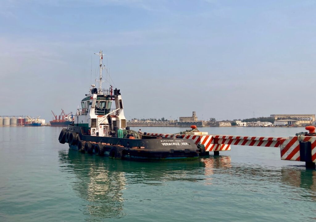 Harbor tugboat in port representing the commercial vessel types that require fuel water separator sizing