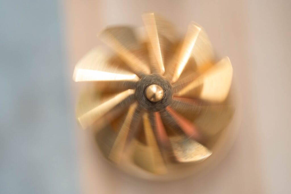 Close-up of a bronze marine pump impeller showing vane detail, the fastest-wearing component in saltwater cooling circuits on Yanmar auxiliary engines